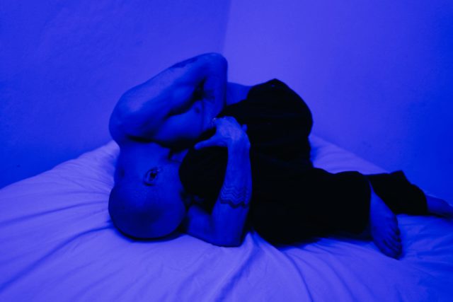 photo of man lying on bed
