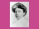 Retrato antiguo en blanco y negro de Margaret Floy Washburn, con el pelo recogido, sobre fondo rosa