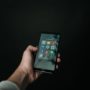 photo of hand holding a black smartphone