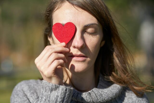 woman holding heart shaped cut out